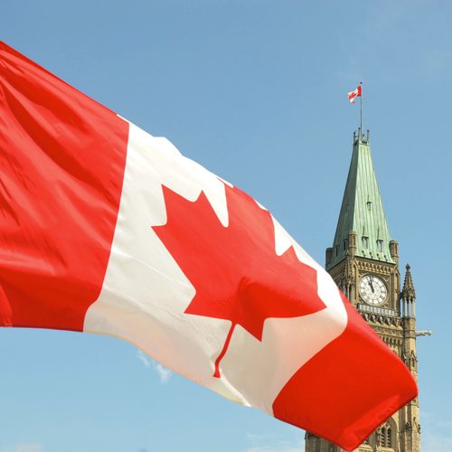 The Canadian flag flying before the Peace Tower in Ottawa